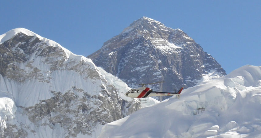 Helicopter flies in front of Everest
